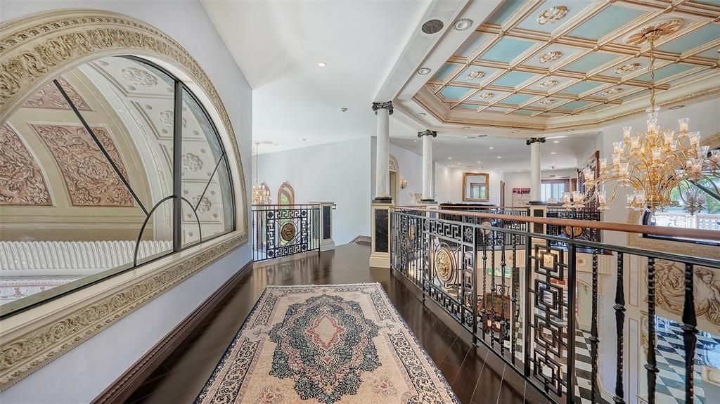 Featuring imported marble floors, Venetian plaster walls, and gold leaf moldings, the residence exudes Old World elegance. Enjoy breathtaking sunsets from terraces, gardens, or the Versace-inspired pool area.