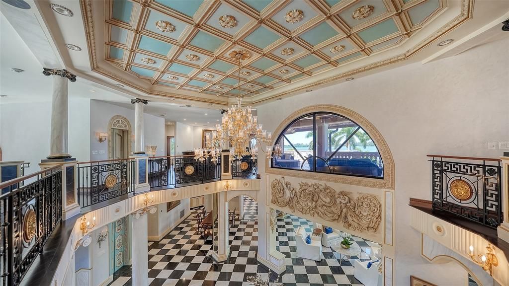 Featuring imported marble floors, Venetian plaster walls, and gold leaf moldings, the residence exudes Old World elegance. Enjoy breathtaking sunsets from terraces, gardens, or the Versace-inspired pool area.