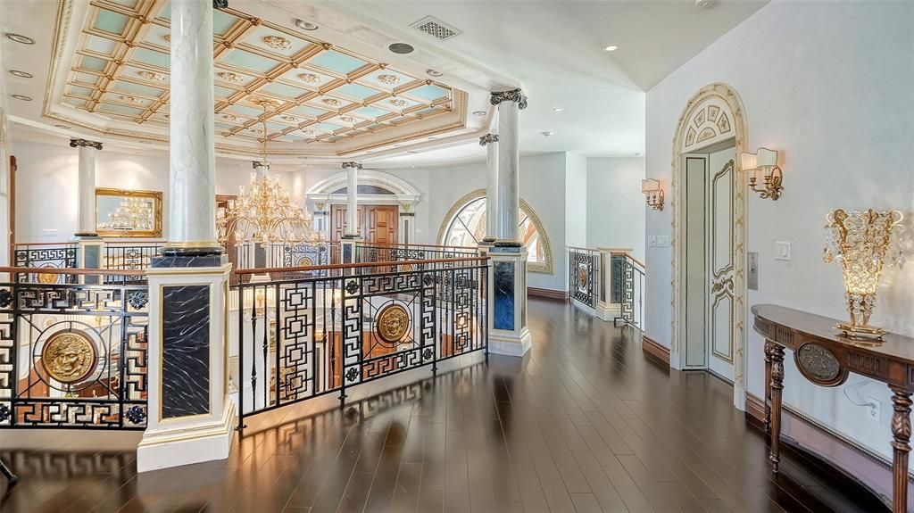 Featuring imported marble floors, Venetian plaster walls, and gold leaf moldings, the residence exudes Old World elegance. Enjoy breathtaking sunsets from terraces, gardens, or the Versace-inspired pool area.