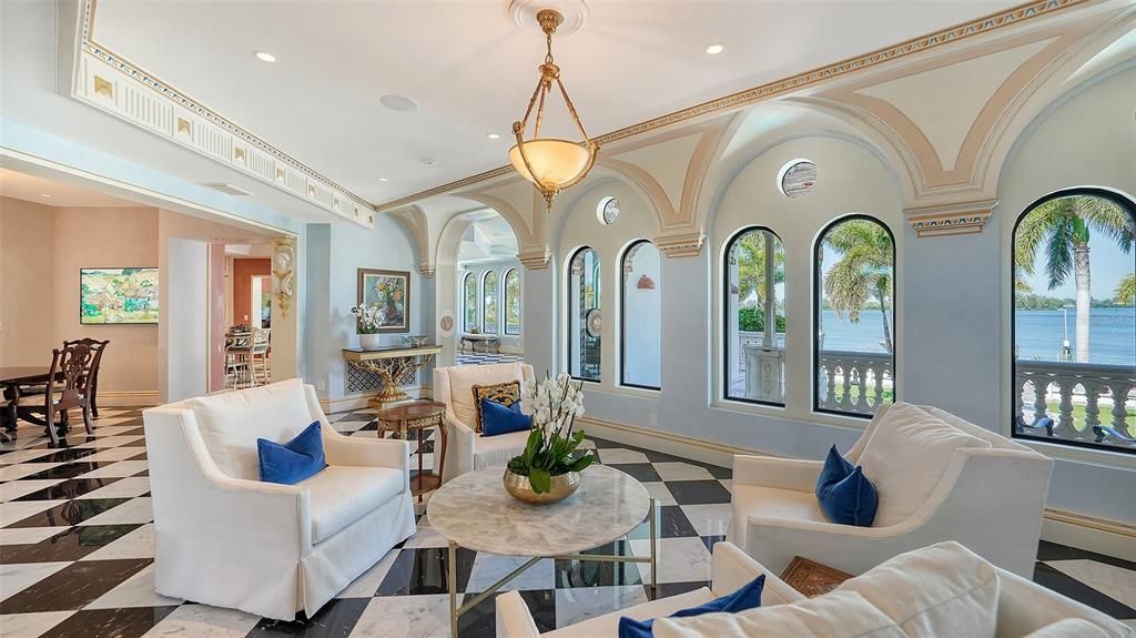 Featuring imported marble floors, Venetian plaster walls, and gold leaf moldings, the residence exudes Old World elegance. Enjoy breathtaking sunsets from terraces, gardens, or the Versace-inspired pool area.