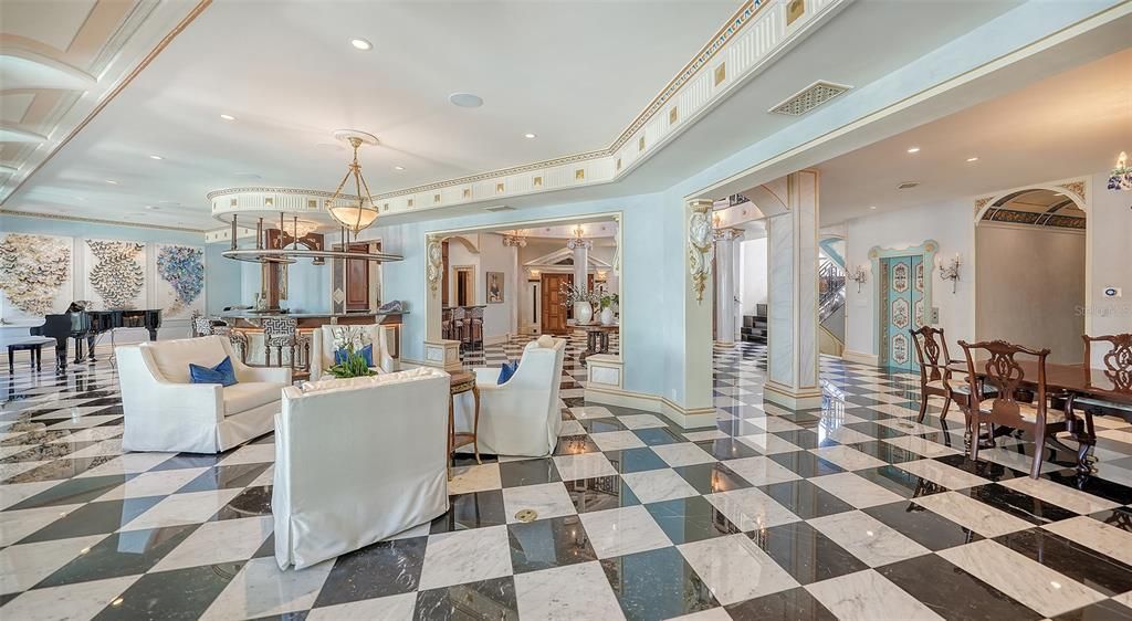 Featuring imported marble floors, Venetian plaster walls, and gold leaf moldings, the residence exudes Old World elegance. Enjoy breathtaking sunsets from terraces, gardens, or the Versace-inspired pool area.