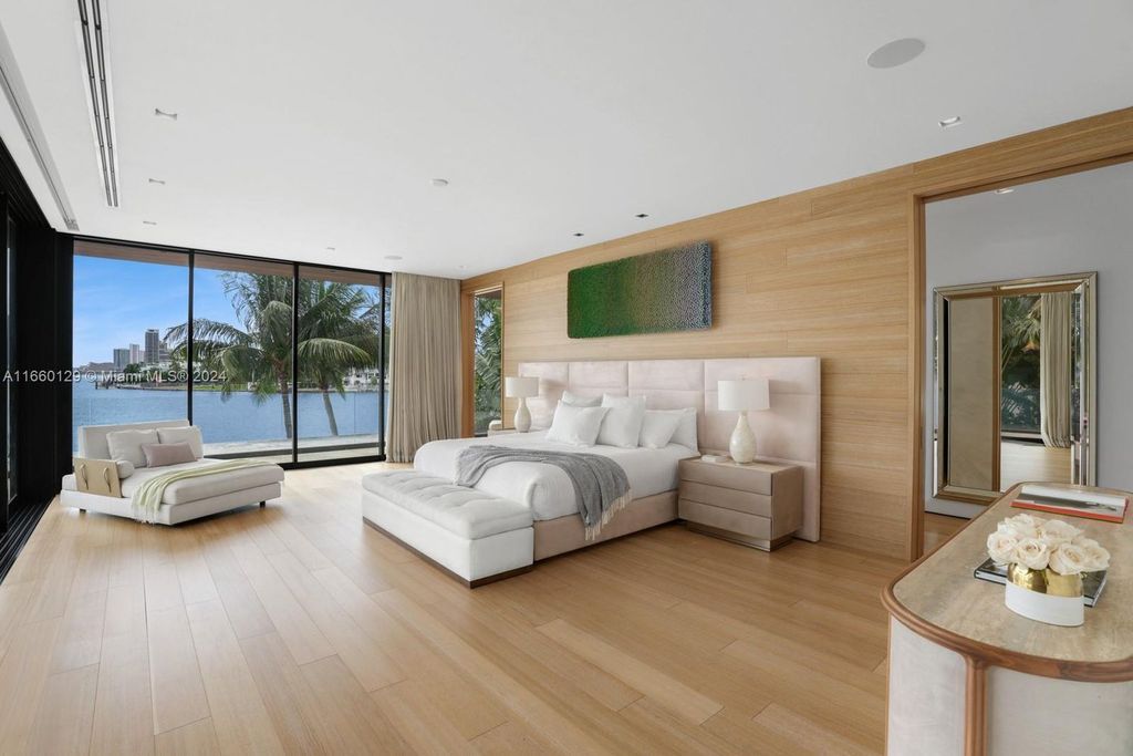 This 5-bed, 7-bath modern masterpiece at 126 W San Marino Dr boasts 90 ft of waterfront and downtown views.