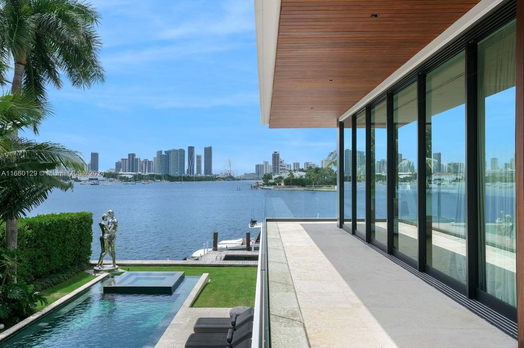 This 5-bed, 7-bath modern masterpiece at 126 W San Marino Dr boasts 90 ft of waterfront and downtown views.