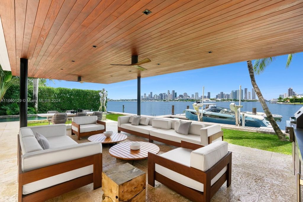 This 5-bed, 7-bath modern masterpiece at 126 W San Marino Dr boasts 90 ft of waterfront and downtown views.