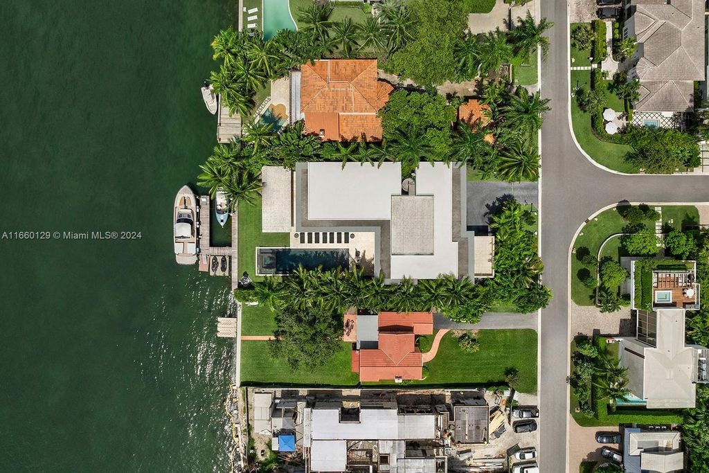 This 5-bed, 7-bath modern masterpiece at 126 W San Marino Dr boasts 90 ft of waterfront and downtown views.