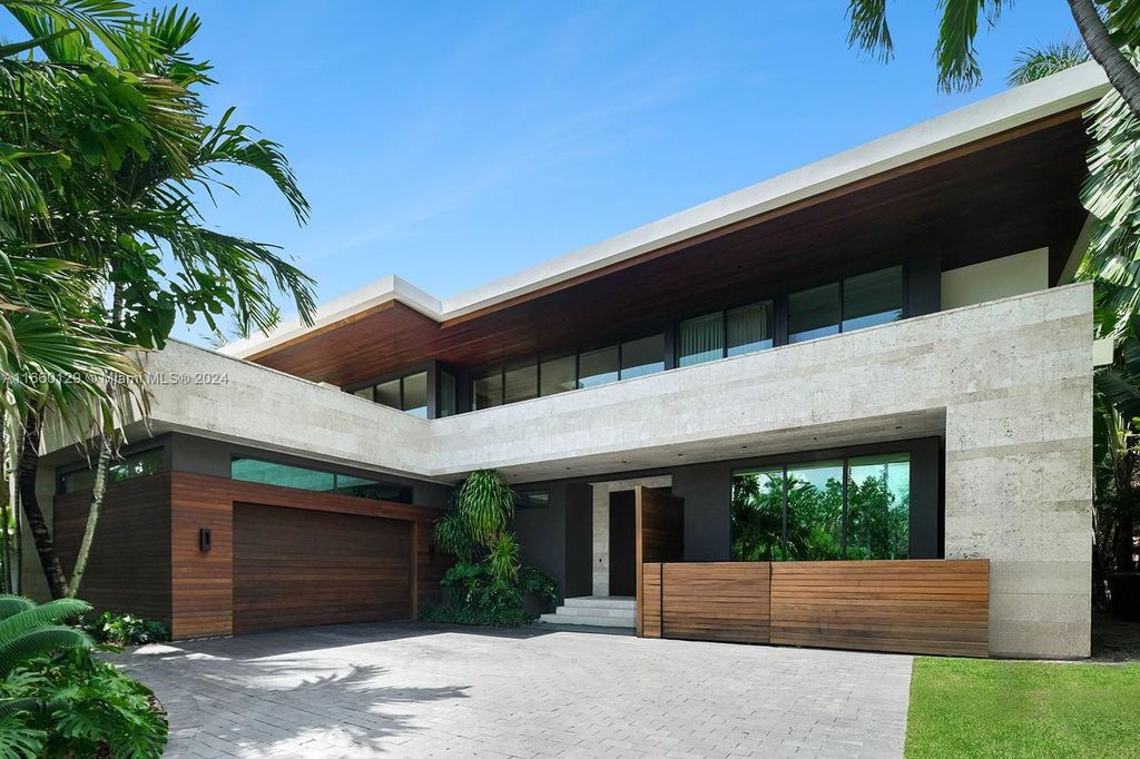 This 5-bed, 7-bath modern masterpiece at 126 W San Marino Dr boasts 90 ft of waterfront and downtown views.