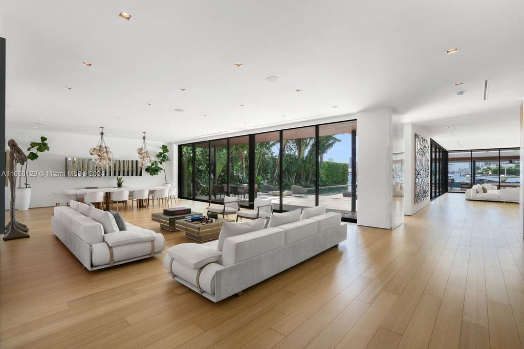 This 5-bed, 7-bath modern masterpiece at 126 W San Marino Dr boasts 90 ft of waterfront and downtown views.