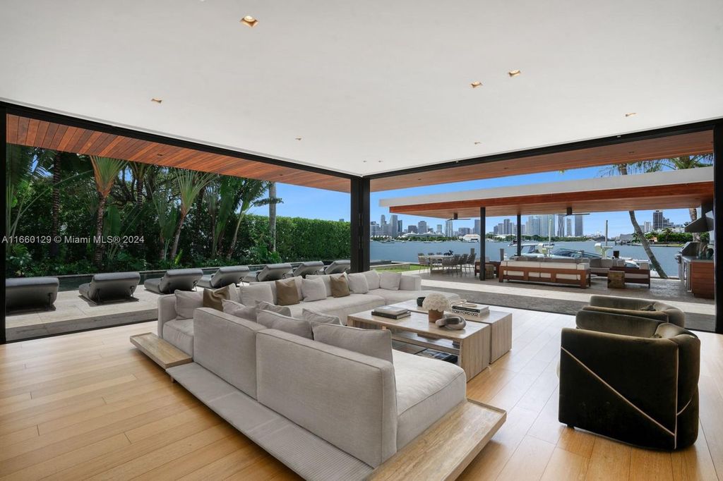 This 5-bed, 7-bath modern masterpiece at 126 W San Marino Dr boasts 90 ft of waterfront and downtown views.