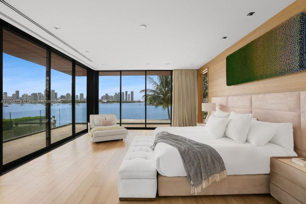 This 5-bed, 7-bath modern masterpiece at 126 W San Marino Dr boasts 90 ft of waterfront and downtown views.