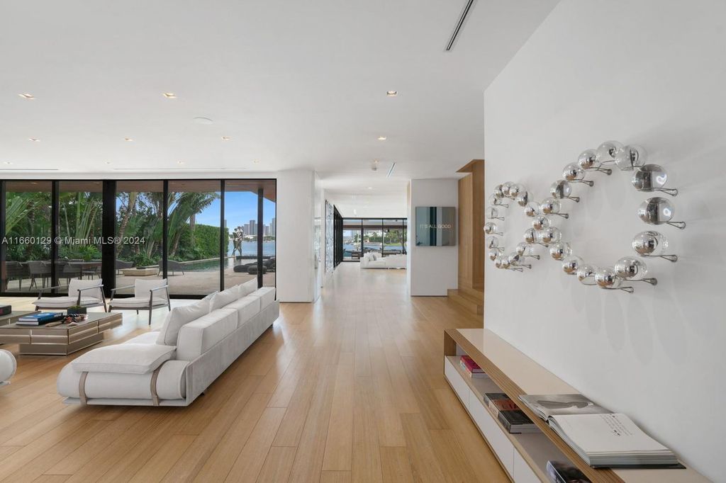 This 5-bed, 7-bath modern masterpiece at 126 W San Marino Dr boasts 90 ft of waterfront and downtown views.