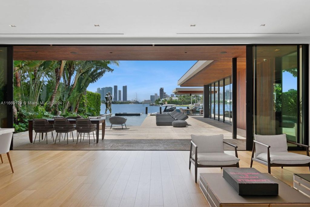 This 5-bed, 7-bath modern masterpiece at 126 W San Marino Dr boasts 90 ft of waterfront and downtown views.