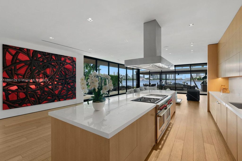 This 5-bed, 7-bath modern masterpiece at 126 W San Marino Dr boasts 90 ft of waterfront and downtown views.