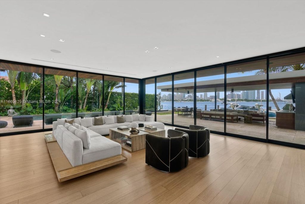 This 5-bed, 7-bath modern masterpiece at 126 W San Marino Dr boasts 90 ft of waterfront and downtown views.