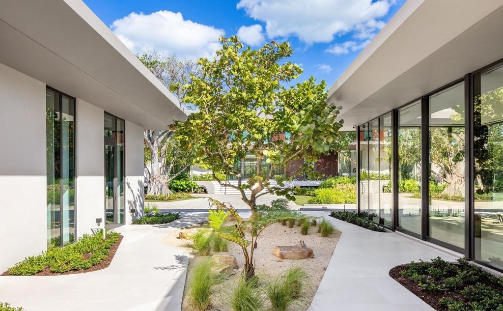 This exceptional oceanfront estate on Jupiter Island, crafted by DOMO Architecture and Design, offers 6 bedrooms, 8 baths, and 10,545 square feet of living space on 3.41 acres with 179 feet of ocean frontage.