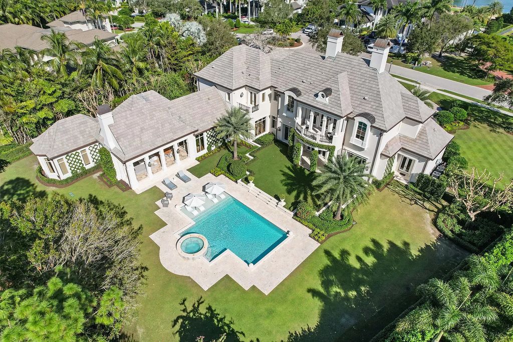 Set on a 1.09-acre lot, this 5-bedroom, 8,589-sf home in the sought-after Old Palm Golf Club combines timeless European design with modern upgrades.