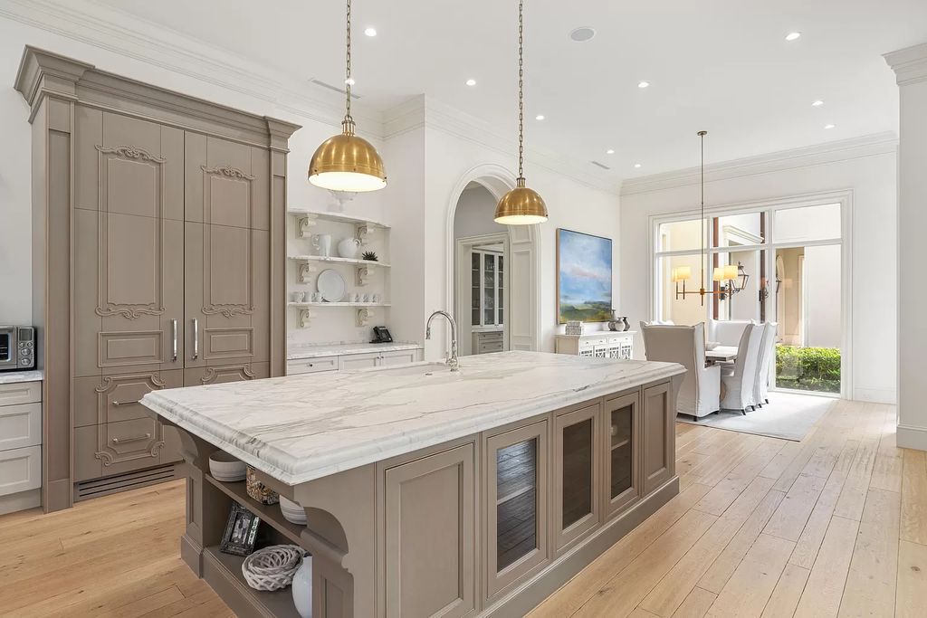 Set on a 1.09-acre lot, this 5-bedroom, 8,589-sf home in the sought-after Old Palm Golf Club combines timeless European design with modern upgrades.