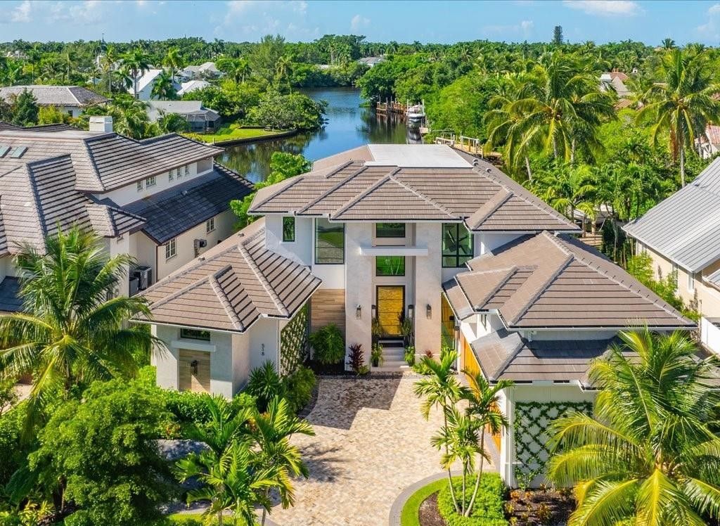 This stunning coastal masterpiece in Aqualane Shores, built in 2021, offers an unparalleled waterfront lifestyle with sweeping views of Jamaica Cove.