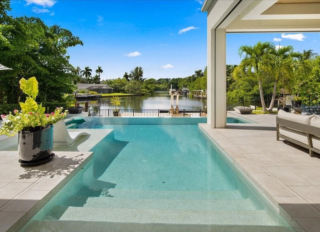 This stunning coastal masterpiece in Aqualane Shores, built in 2021, offers an unparalleled waterfront lifestyle with sweeping views of Jamaica Cove.