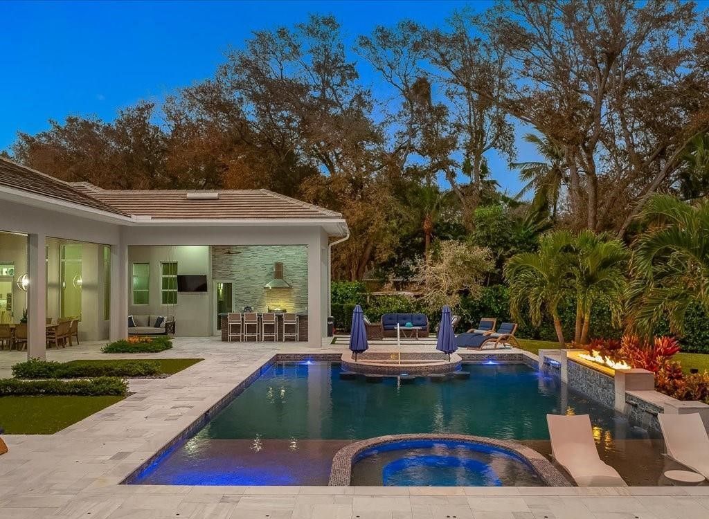 Luxurious $9 Million Coastal Modern Estate in Naples with Lakefront Lanai and Private Beach in Pine Ridge Estates