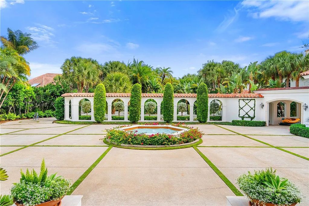 Located in the prestigious Little Harbour community, this magnificent Mizner-inspired Cote d'Azur estate offers 5 bedrooms, 7 full baths, and 2 half baths across 6,812± square feet.