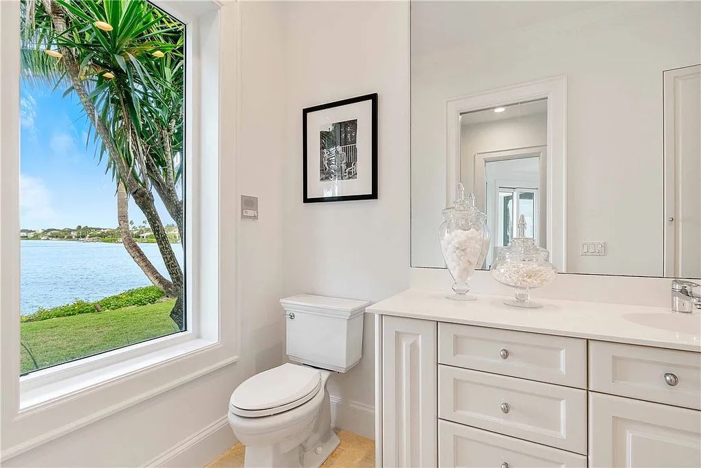 Located in the prestigious Little Harbour community, this magnificent Mizner-inspired Cote d'Azur estate offers 5 bedrooms, 7 full baths, and 2 half baths across 6,812± square feet.