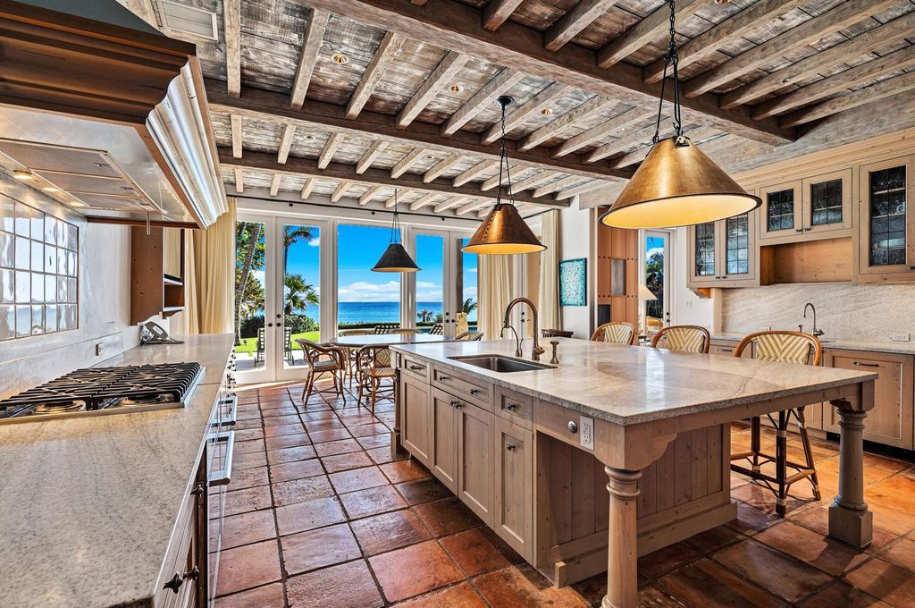 This stunning 8-bedroom, 9-bathroom estate spans 9,855 square feet and evokes the charm of Lake Como’s iconic villas. Designed by John Saladino, it blends rustic sophistication with grand elegance, featuring hand-hewn wood beams, reclaimed terra cotta floors, plaster walls, and a Tejas Borja tile roof.