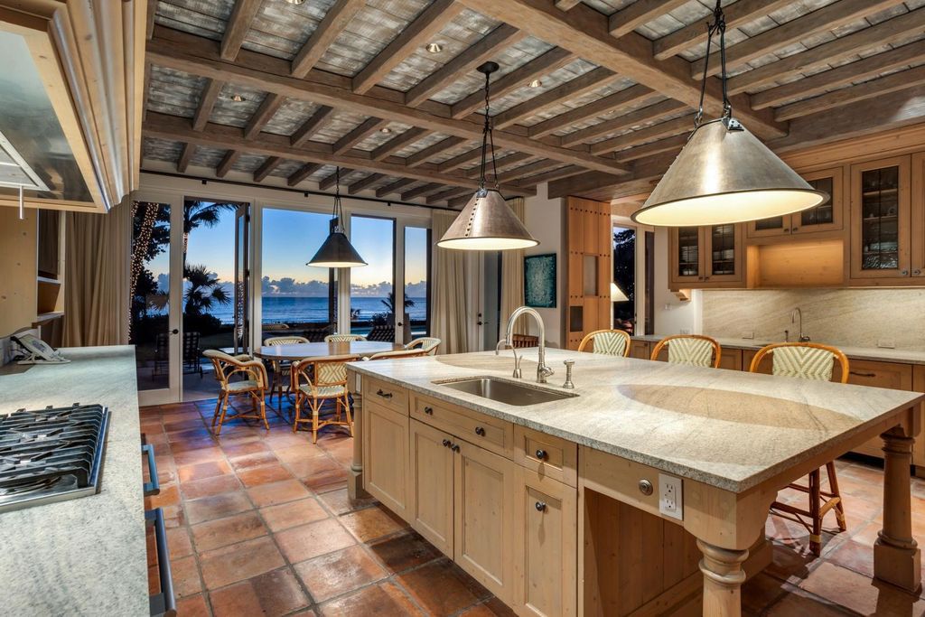 This stunning 8-bedroom, 9-bathroom estate spans 9,855 square feet and evokes the charm of Lake Como’s iconic villas. Designed by John Saladino, it blends rustic sophistication with grand elegance, featuring hand-hewn wood beams, reclaimed terra cotta floors, plaster walls, and a Tejas Borja tile roof.