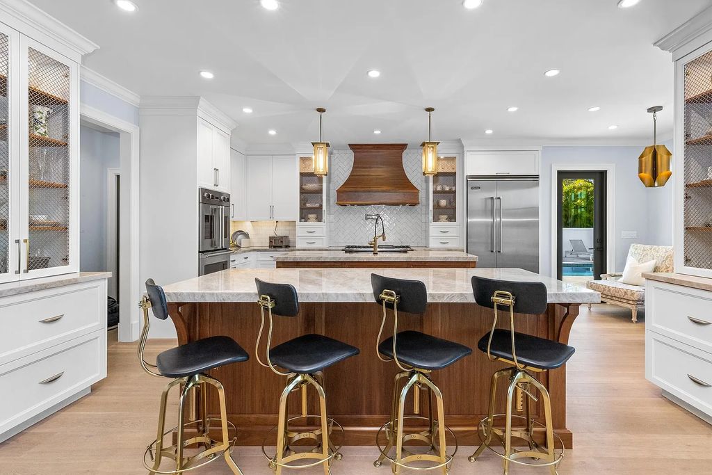 The 3-bedroom main residence features exquisite finishes, including chevron-patterned white oak floors, a striking octagonal living room, and a chef’s kitchen with dual walnut islands, Taj Mahal quartzite countertops, and Viking appliances.