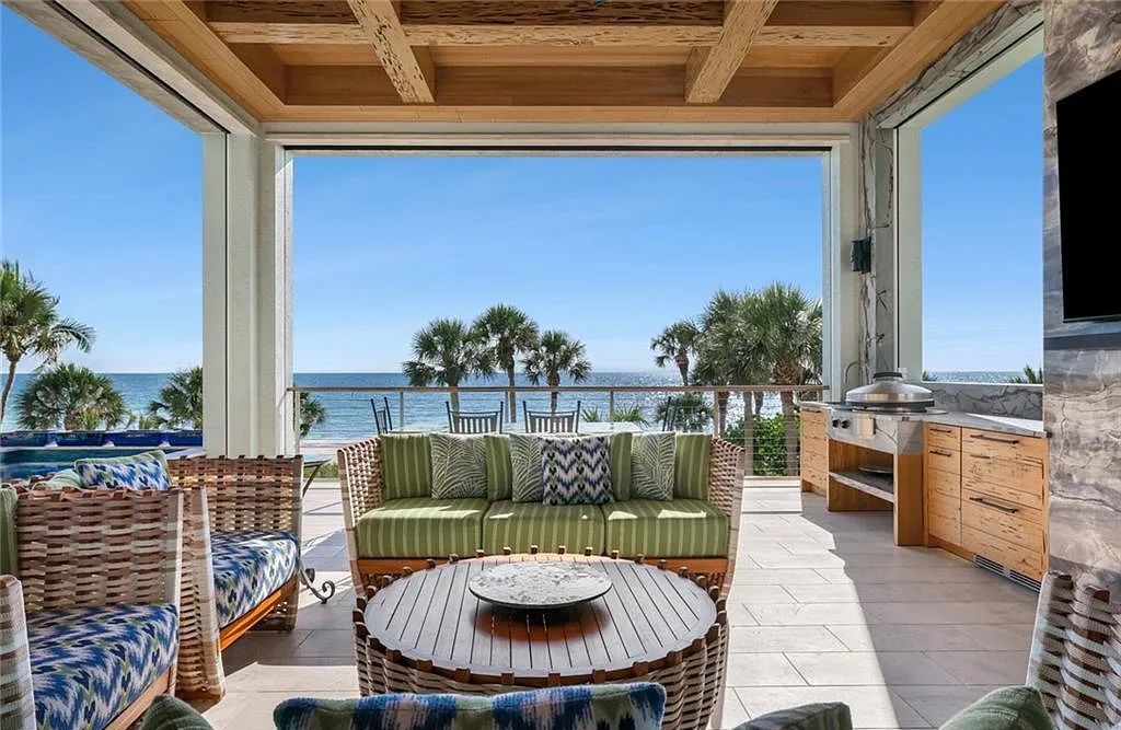 Nestled in the exclusive Strand at Bay Colony, this newly constructed 2023 custom home offers 5 bedrooms, 6 baths, and 7,210 square feet of refined living space on a 0.60-acre beachfront lot.