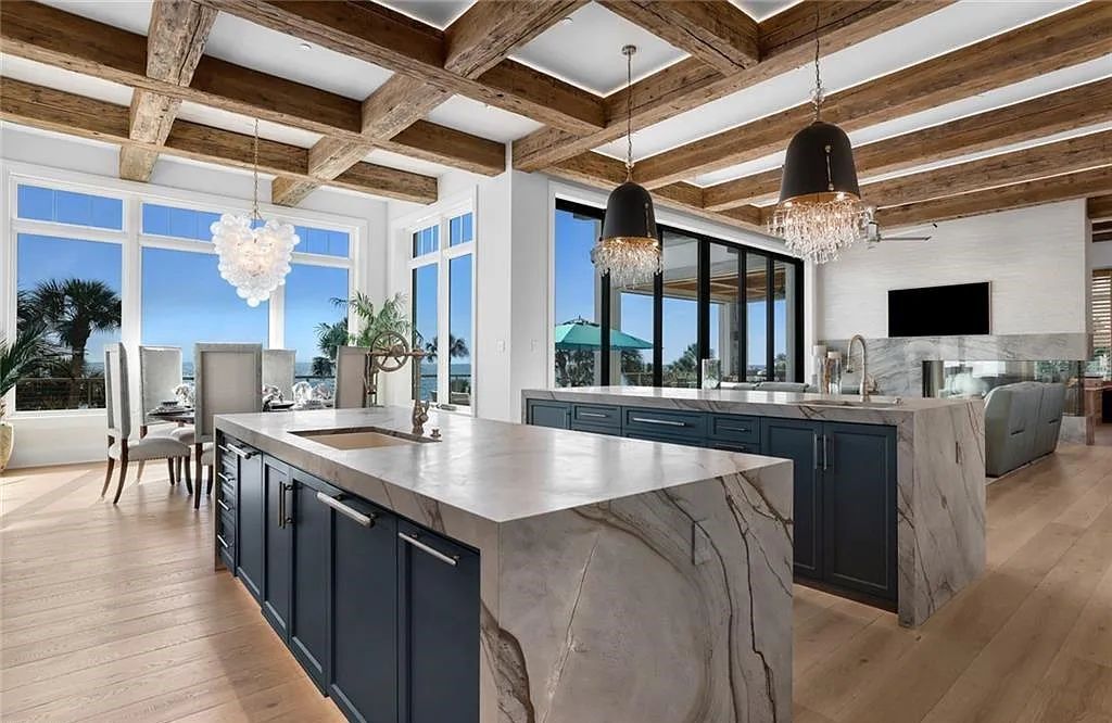 Nestled in the exclusive Strand at Bay Colony, this newly constructed 2023 custom home offers 5 bedrooms, 6 baths, and 7,210 square feet of refined living space on a 0.60-acre beachfront lot.