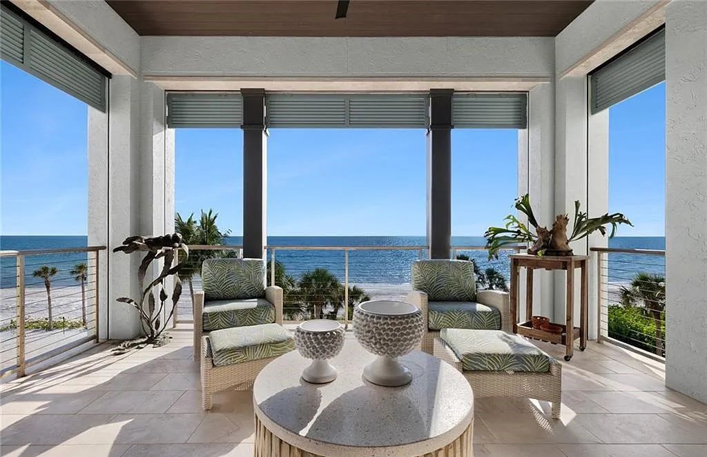 Nestled in the exclusive Strand at Bay Colony, this newly constructed 2023 custom home offers 5 bedrooms, 6 baths, and 7,210 square feet of refined living space on a 0.60-acre beachfront lot.