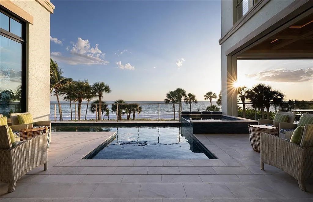 Nestled in the exclusive Strand at Bay Colony, this newly constructed 2023 custom home offers 5 bedrooms, 6 baths, and 7,210 square feet of refined living space on a 0.60-acre beachfront lot.