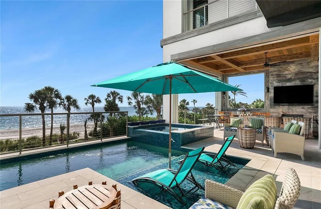 Nestled in the exclusive Strand at Bay Colony, this newly constructed 2023 custom home offers 5 bedrooms, 6 baths, and 7,210 square feet of refined living space on a 0.60-acre beachfront lot.