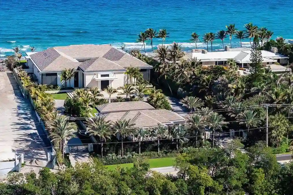 Aerial view of 1160 S Ocean Boulevard in Manalapan, showcasing its expansive two-acre lot, direct ocean frontage, and exclusive private dock