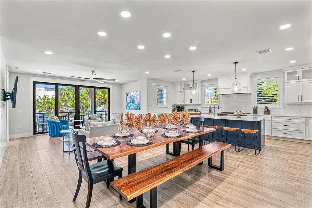 A breathtaking coastal retreat at 119 Avenida Messina, Sarasota, featuring modern architecture, wraparound balconies, and lush tropical landscaping.