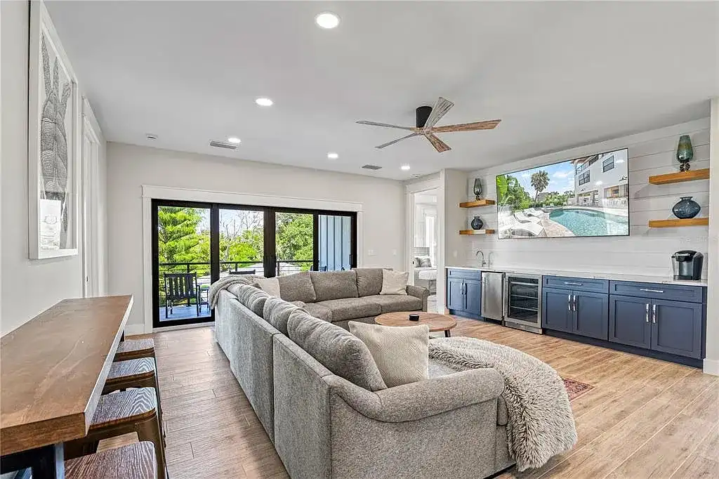 A breathtaking coastal retreat at 119 Avenida Messina, Sarasota, featuring modern architecture, wraparound balconies, and lush tropical landscaping.