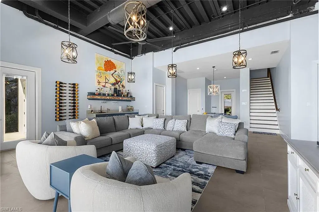 Spacious great room at 215 Barefoot Beach Blvd – High ceilings, floor-to-ceiling windows, and seamless indoor-outdoor living.