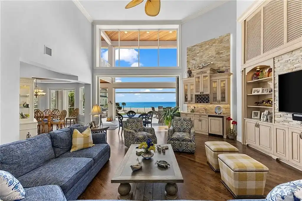 Spacious great room at 215 Barefoot Beach Blvd – High ceilings, floor-to-ceiling windows, and seamless indoor-outdoor living.