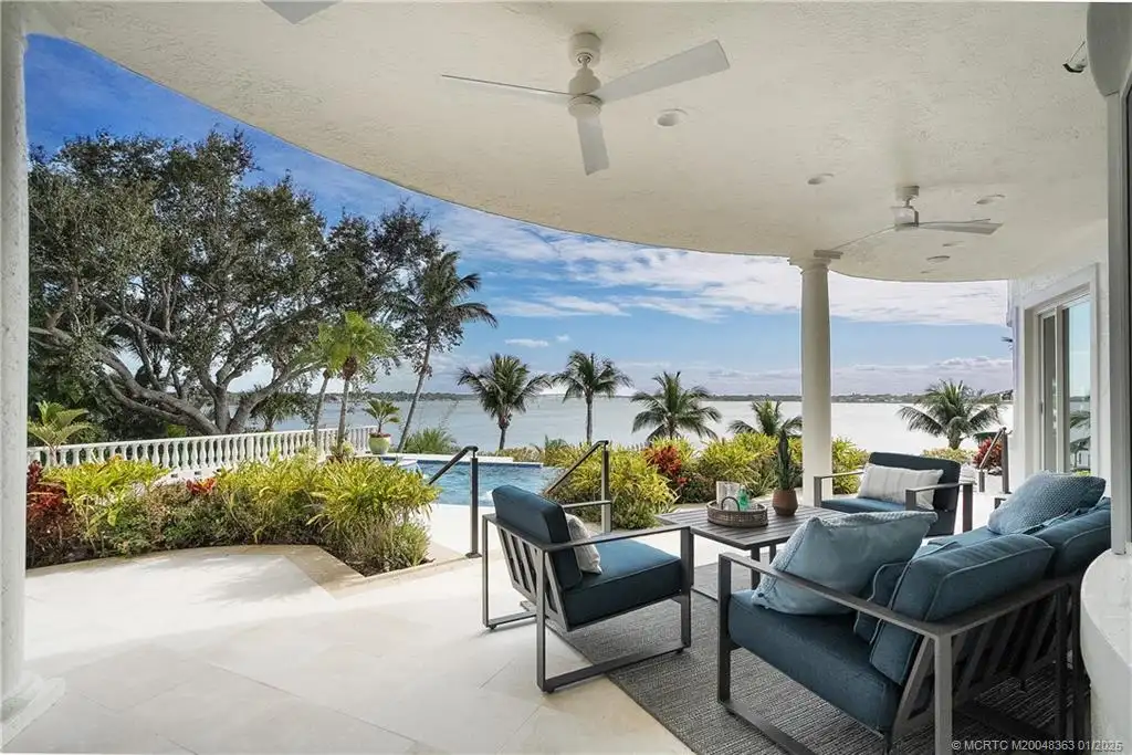 Luxurious waterfront estate in Sewalls Point featuring panoramic water views, resort-style pool, private boat lifts, and elegant architectural design. Perfect Sewalls Pt home for sale with 6 bedrooms, 7 baths, and modern amenities.