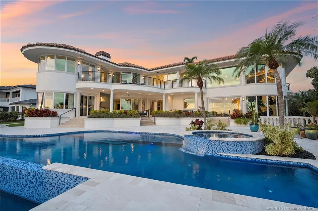 Luxurious waterfront estate in Sewalls Point featuring panoramic water views, resort-style pool, private boat lifts, and elegant architectural design. Perfect Sewalls Pt home for sale with 6 bedrooms, 7 baths, and modern amenities.