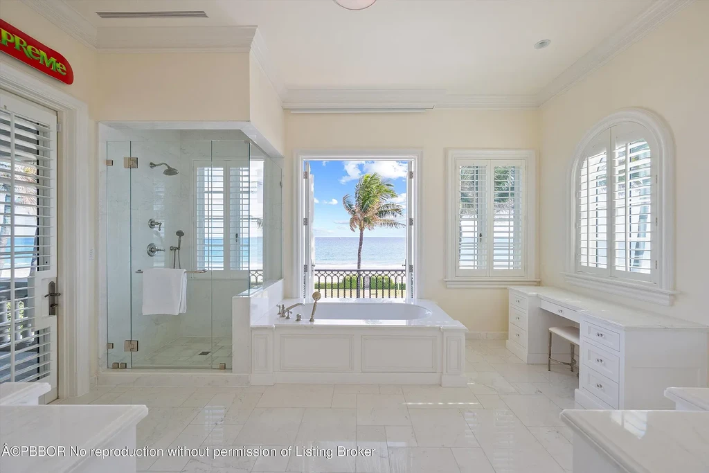 Front view of the Mediterranean-style estate at 516 S Ocean Blvd, Palm Beach, featuring oceanfront access and lush landscaping.