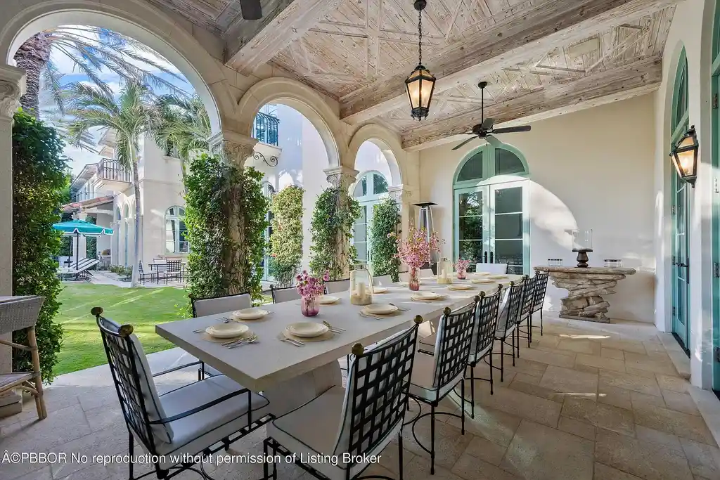 Front view of the Mediterranean-style estate at 516 S Ocean Blvd, Palm Beach, featuring oceanfront access and lush landscaping.