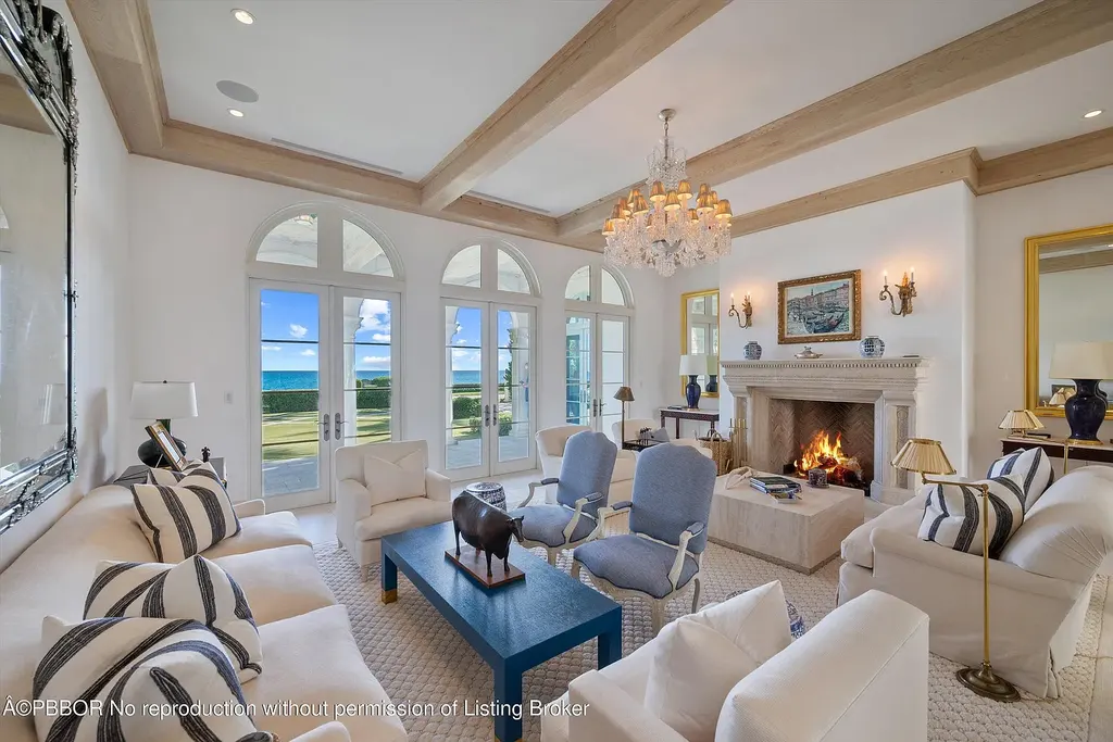 Front view of the Mediterranean-style estate at 516 S Ocean Blvd, Palm Beach, featuring oceanfront access and lush landscaping.