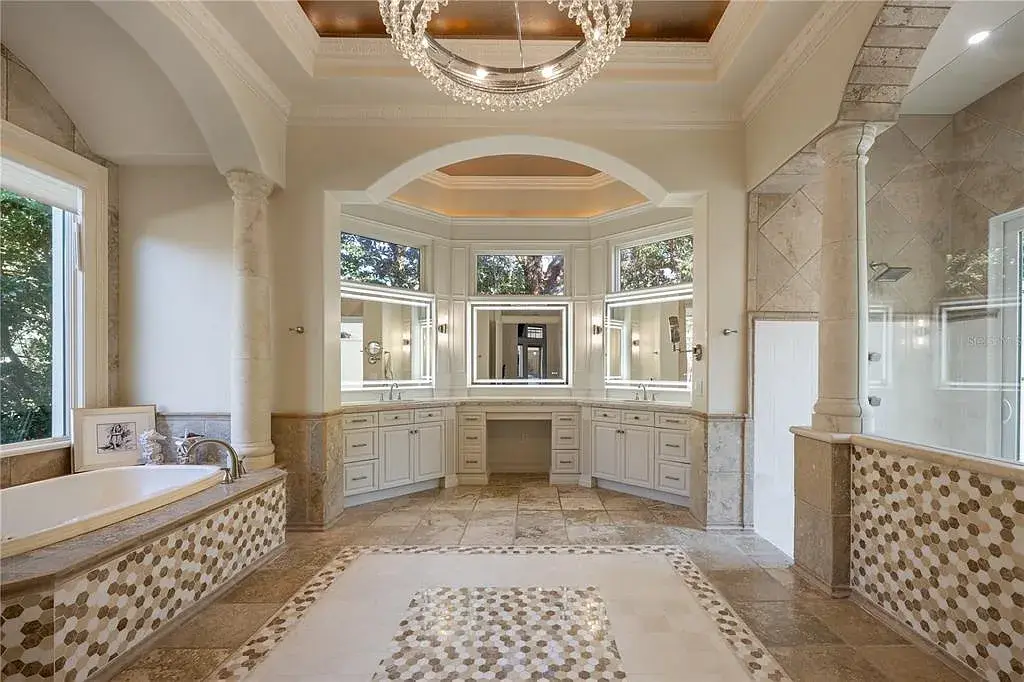 A state-of-the-art kitchen at 6126 Kirkstone Ln, designed with marble countertops, a large center island, and premium appliances.