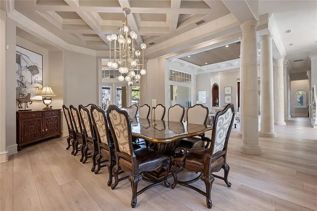 A state-of-the-art kitchen at 6126 Kirkstone Ln, designed with marble countertops, a large center island, and premium appliances.