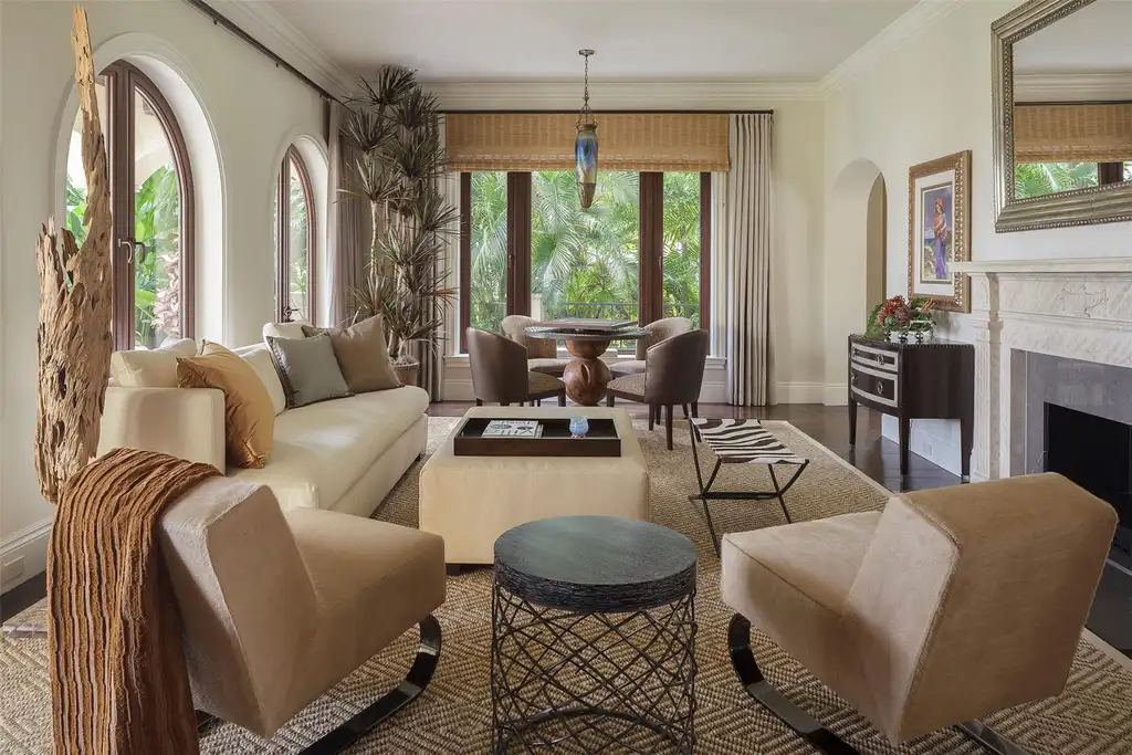 Elegant living room at 815 Idlewyld Dr featuring a gas fireplace, custom onyx bar, and a 1,000-gallon saltwater aquarium.