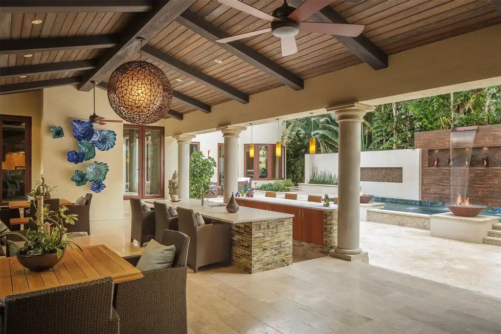 Elegant living room at 815 Idlewyld Dr featuring a gas fireplace, custom onyx bar, and a 1,000-gallon saltwater aquarium.