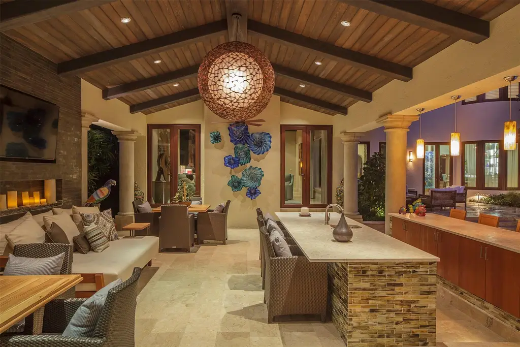 Elegant living room at 815 Idlewyld Dr featuring a gas fireplace, custom onyx bar, and a 1,000-gallon saltwater aquarium.