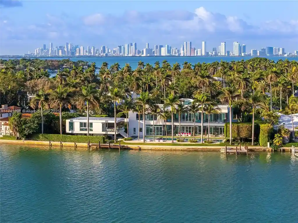 Exterior view of 88 La Gorce Cir, a $88M waterfront luxury estate in Miami Beach, showcasing modern architecture, a Guggenheim-inspired staircase, and breathtaking bay views.