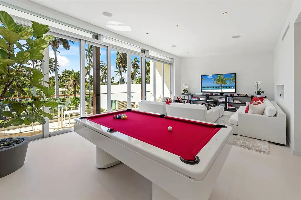 Exterior view of 88 La Gorce Cir, a $88M waterfront luxury estate in Miami Beach, showcasing modern architecture, a Guggenheim-inspired staircase, and breathtaking bay views.